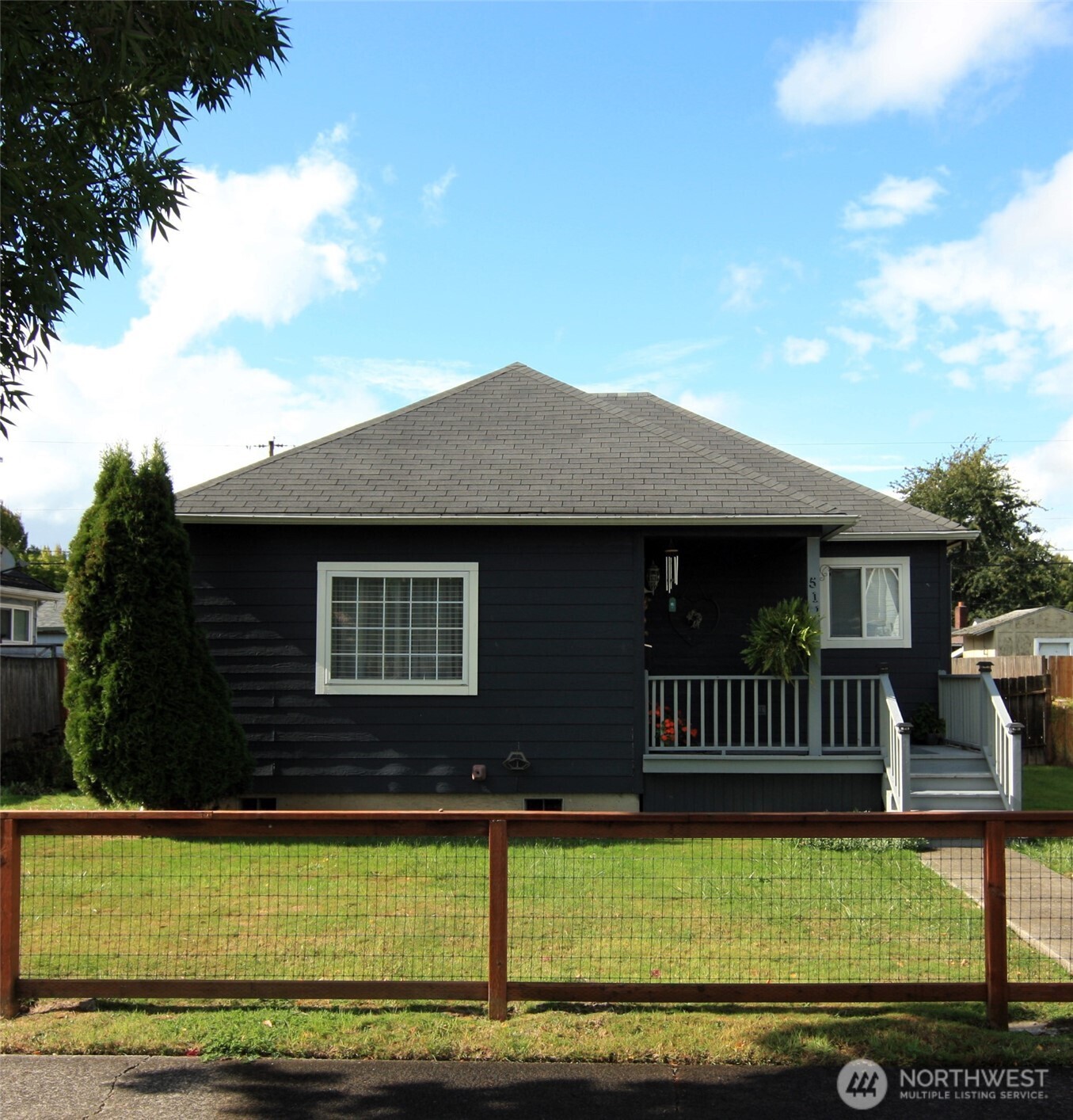 a front view of a house with a garden