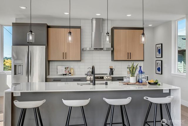 a kitchen with stainless steel appliances kitchen island granite countertop a sink and cabinets