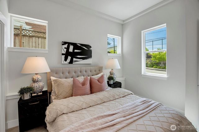 a bedroom with bed and wall painting