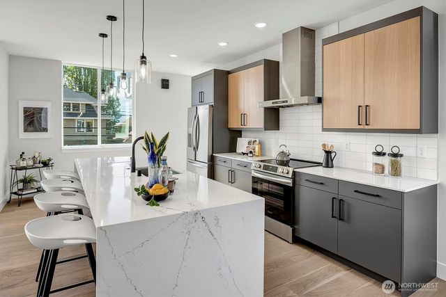 a large kitchen with stainless steel appliances a large island in the center