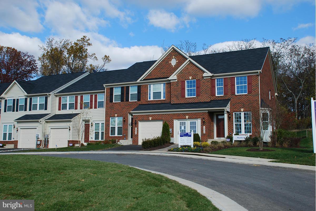 2433 Baileys Pond Road Accokeek, MD 20607 - Photo 1 of 18 front view of residential houses with a yard