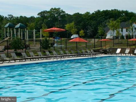 2433 Baileys Pond Road Accokeek, MD 20607 - Photo 6 of 18 a view of a swimming pool with an outdoor seating