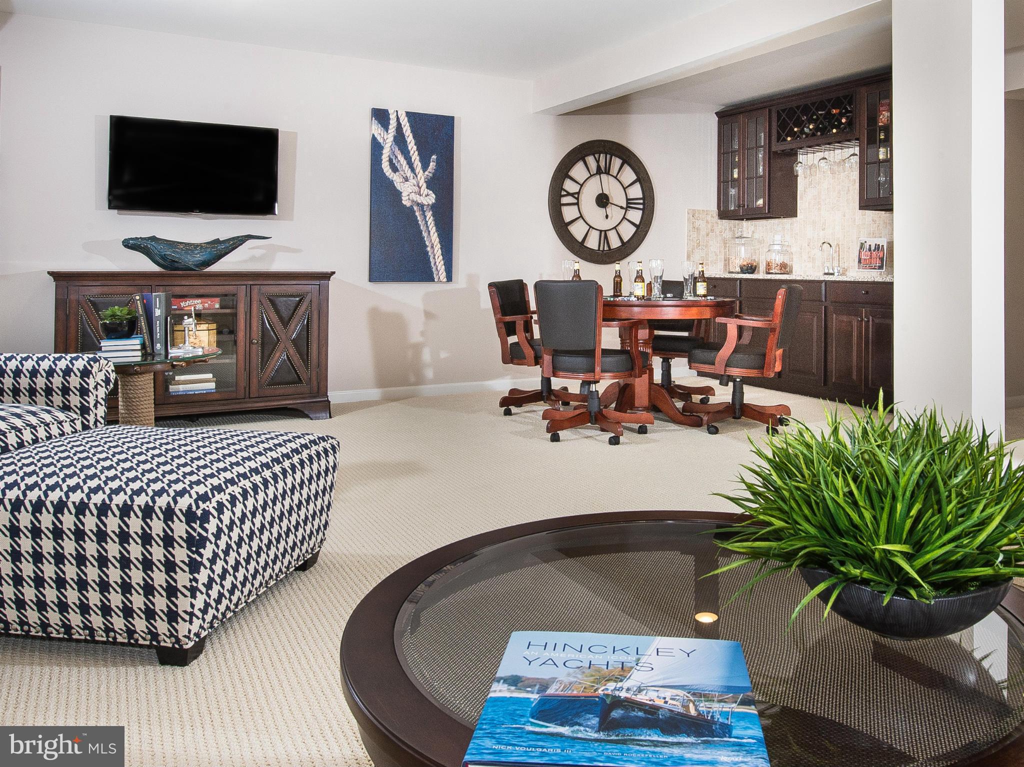 2433 Baileys Pond Road Accokeek, MD 20607 - Photo 8 of 18 a living room with furniture and a flat screen tv