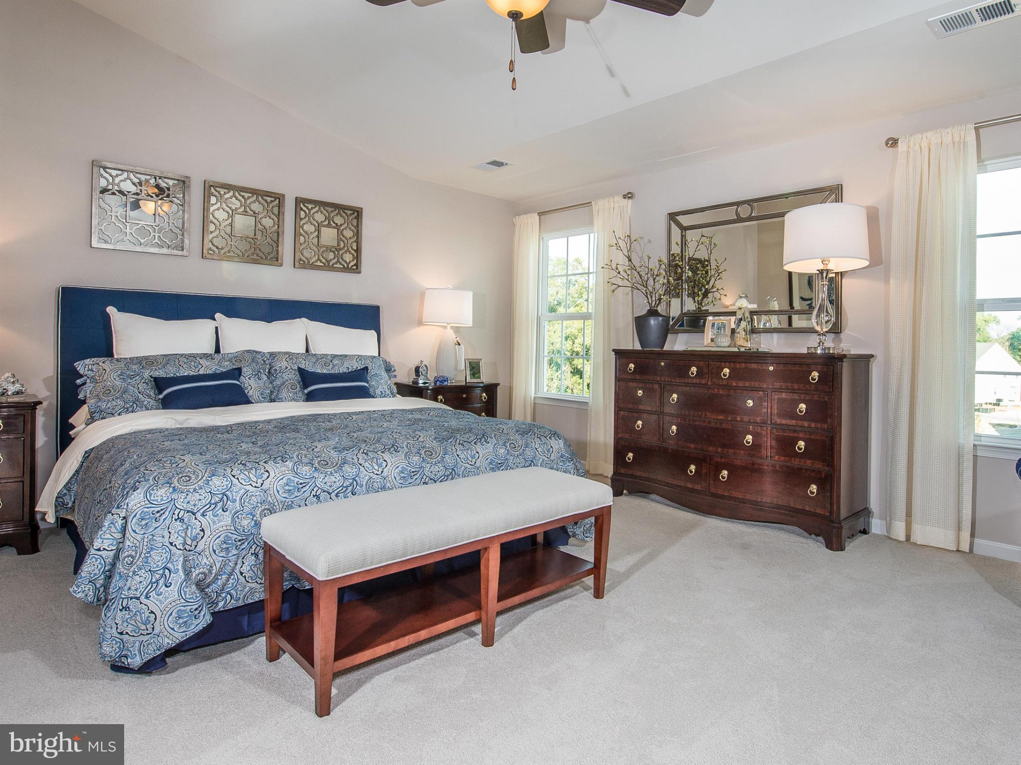 2433 Baileys Pond Road Accokeek, MD 20607 - Photo 10 of 18 a bedroom with a bed and a chandelier