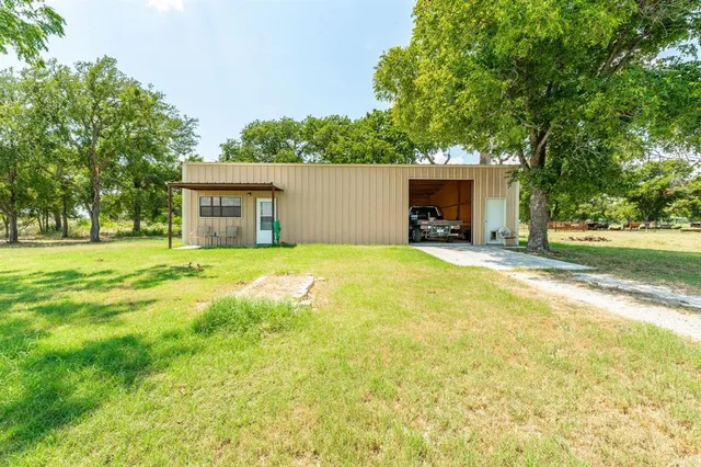 a view of house with yard and garage