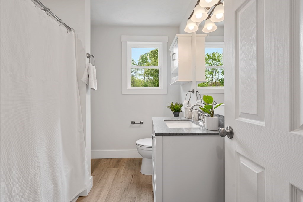 91 Schofield Avenue Dudley, MA 01571 - Photo 17 of 27 a bath room with a sink a toilet and a window