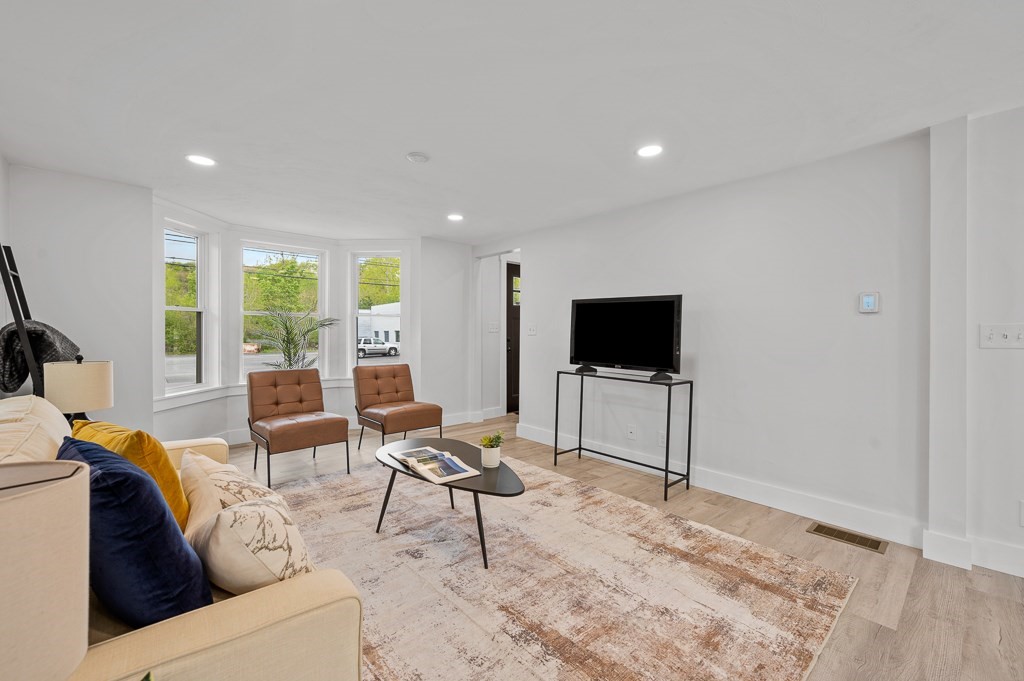 91 Schofield Avenue Dudley, MA 01571 - Photo 5 of 27 a living room with furniture and a flat screen tv