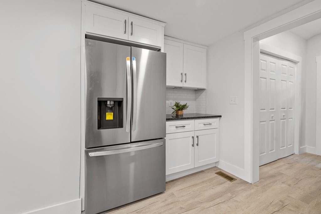 91 Schofield Avenue Dudley, MA 01571 - Photo 8 of 27 a kitchen with appliances a refrigerator and cabinets