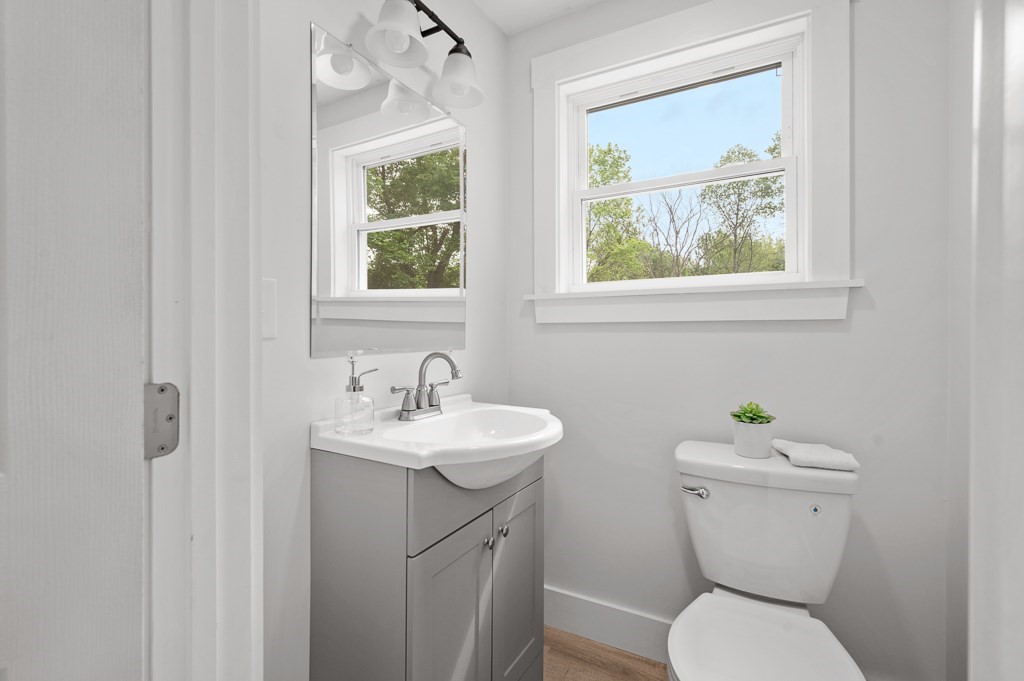 91 Schofield Avenue Dudley, MA 01571 - Photo 10 of 27 a bathroom with a toilet a sink and mirror