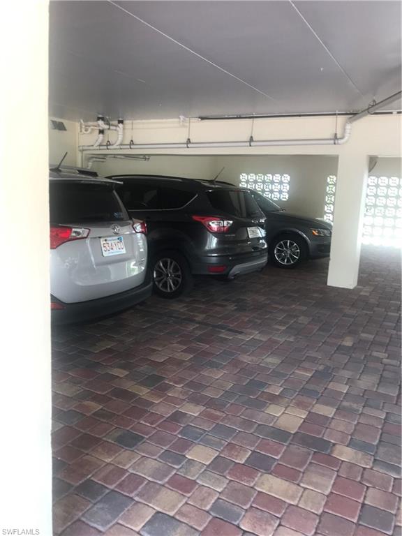 216 Banyan Boulevard, Unit 216 Naples, FL 34102 - Photo 12 of 33 a view of parking garage with cars
