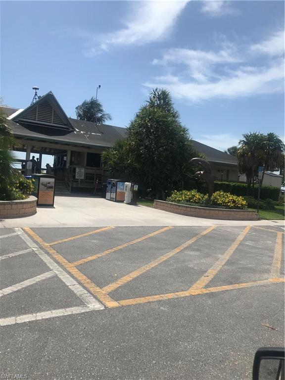 216 Banyan Boulevard, Unit 216 Naples, FL 34102 - Photo 16 of 33 a view of a tennis ground with large trees