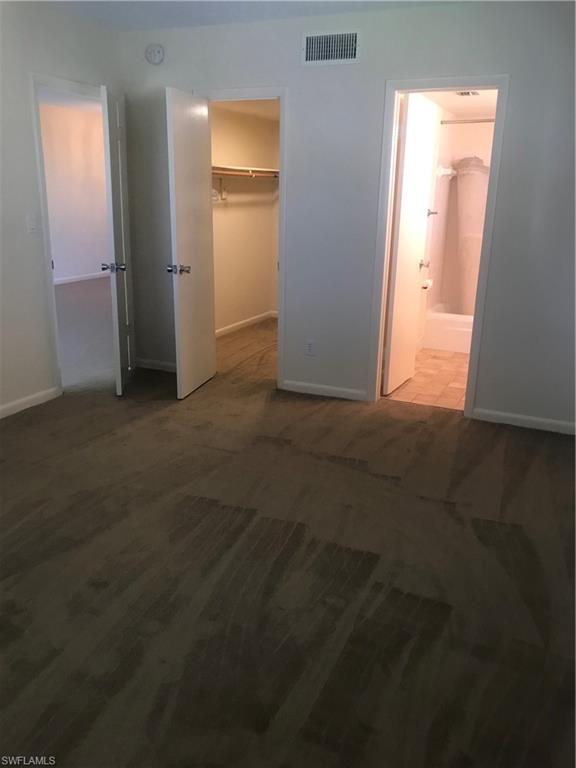 216 Banyan Boulevard, Unit 216 Naples, FL 34102 - Photo 21 of 33 an empty room with closet and windows