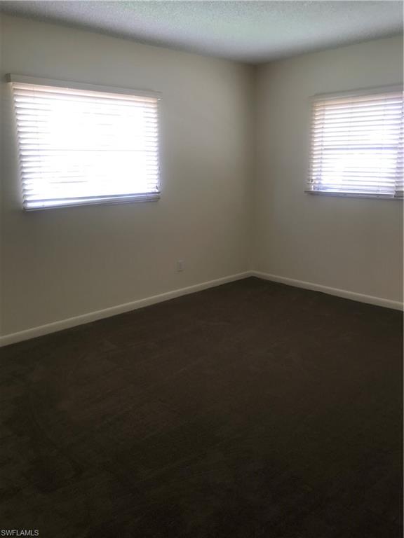 216 Banyan Boulevard, Unit 216 Naples, FL 34102 - Photo 24 of 33 an empty room with a window