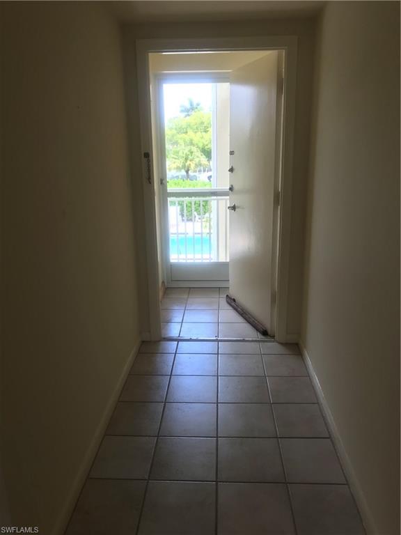 216 Banyan Boulevard, Unit 216 Naples, FL 34102 - Photo 27 of 33 a view of an empty room with a window