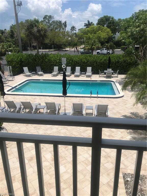 216 Banyan Boulevard, Unit 216 Naples, FL 34102 - Photo 29 of 33 a view of a yard with two chairs and a table