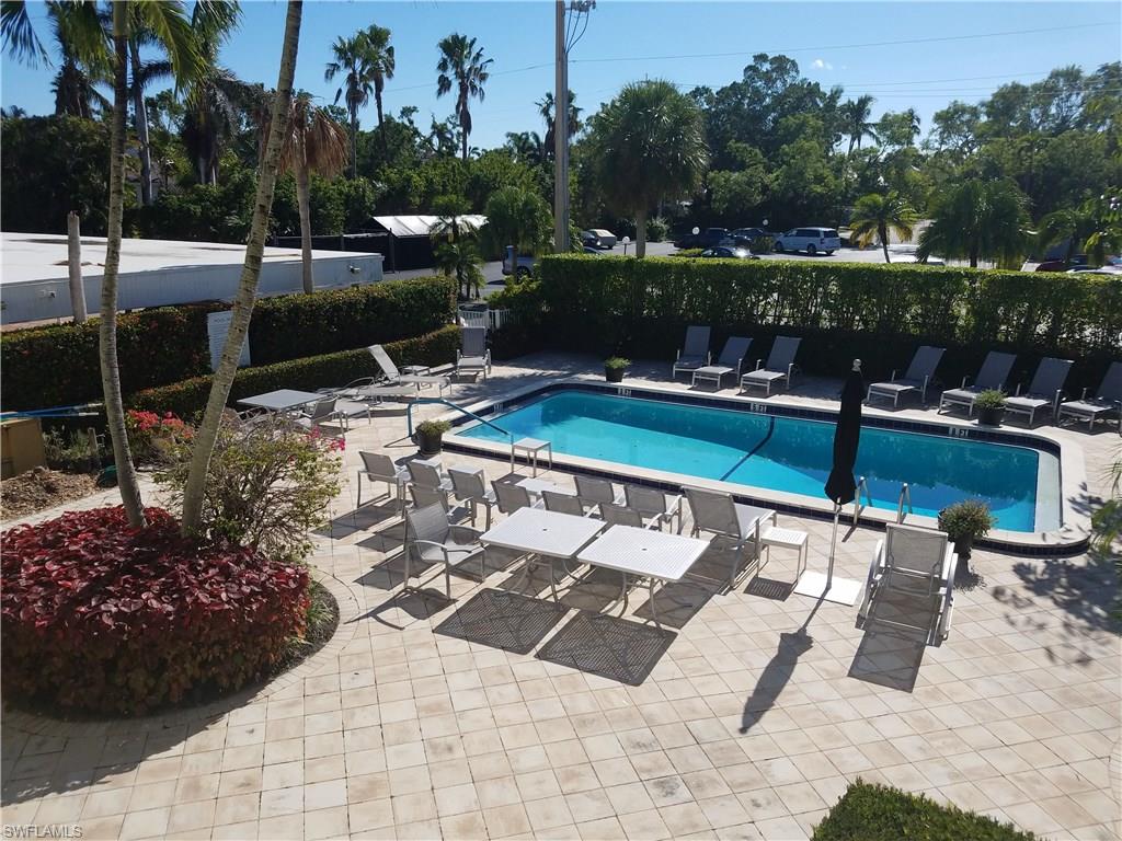 216 Banyan Boulevard, Unit 216 Naples, FL 34102 - Photo 5 of 33 a view of a backyard with sitting area