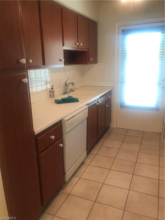 216 Banyan Boulevard, Unit 216 Naples, FL 34102 - Photo 8 of 33 a kitchen with a sink cabinets and appliances