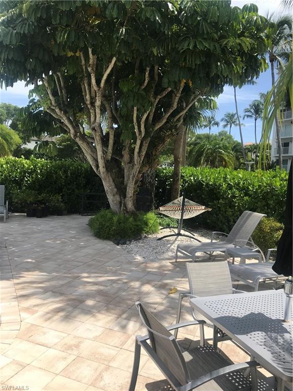 216 Banyan Boulevard, Unit 216 Naples, FL 34102 - Photo 10 of 33 a view of backyard with green space
