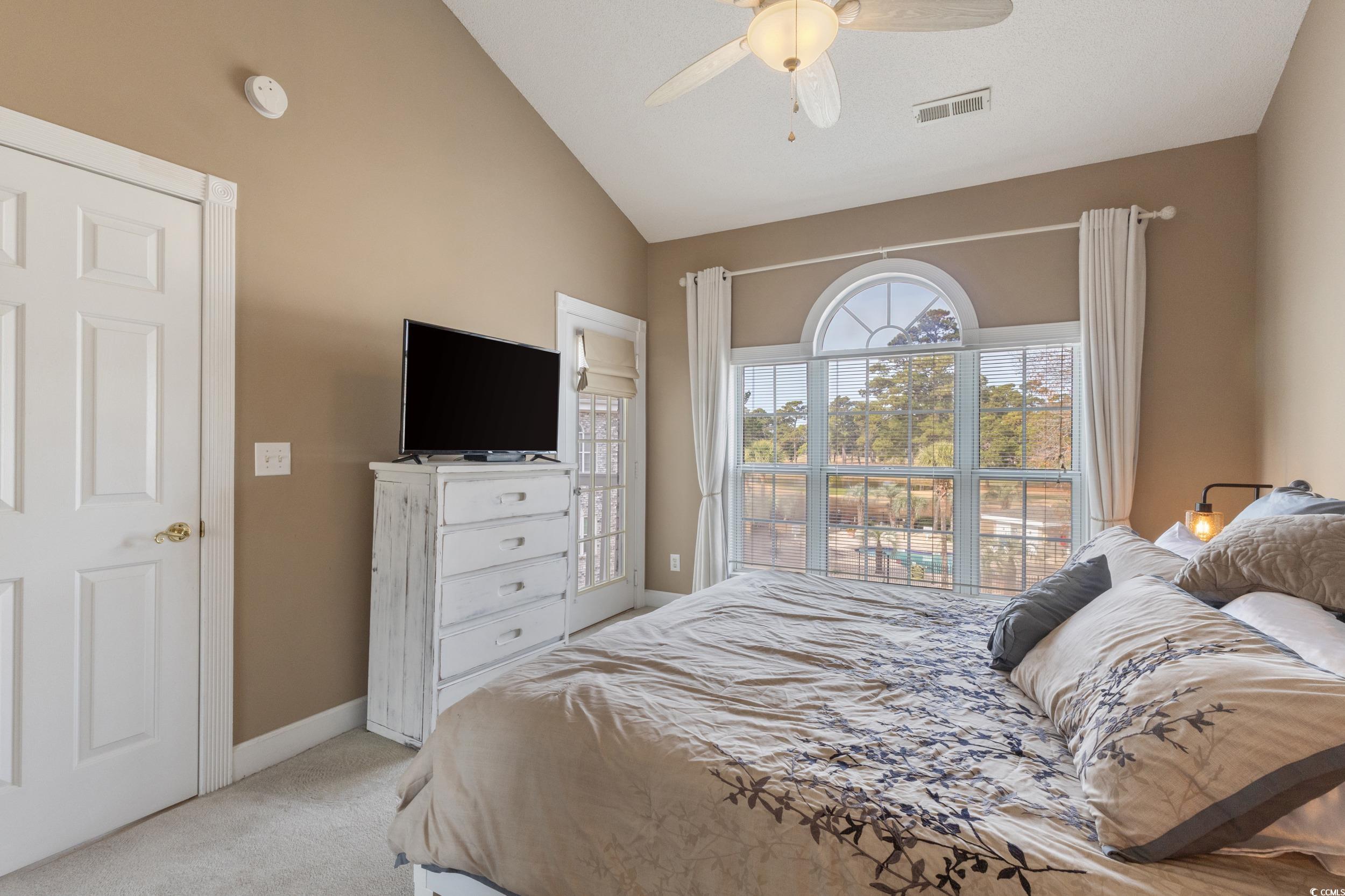 4781 Wild Iris Drive, Unit 301 Myrtle Beach, SC 29577 - Photo 16 of 33 Bedroom with lofted ceiling, carpet flooring, and ceiling fan