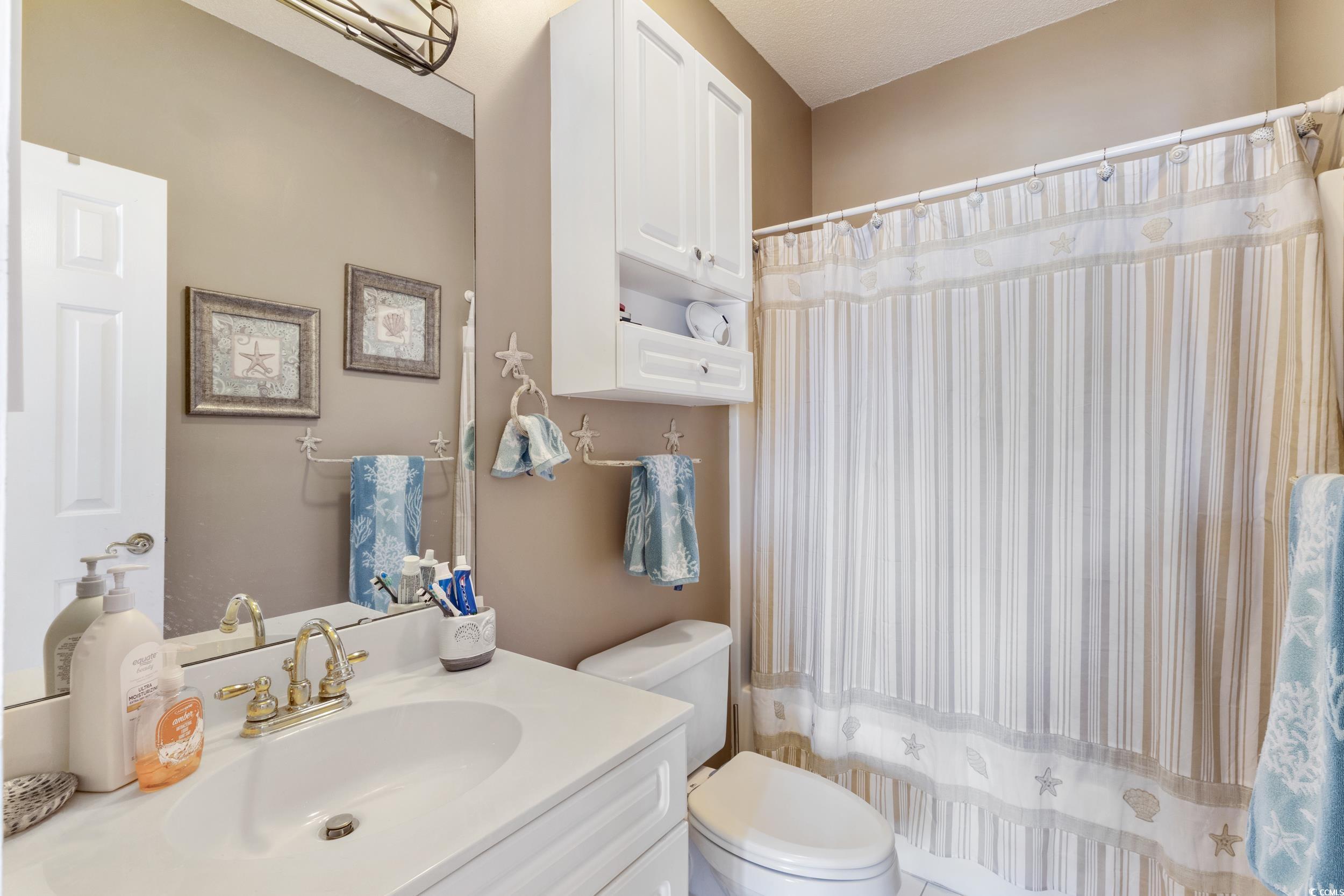 4781 Wild Iris Drive, Unit 301 Myrtle Beach, SC 29577 - Photo 18 of 33 Bathroom featuring vanity and a shower with shower curtain