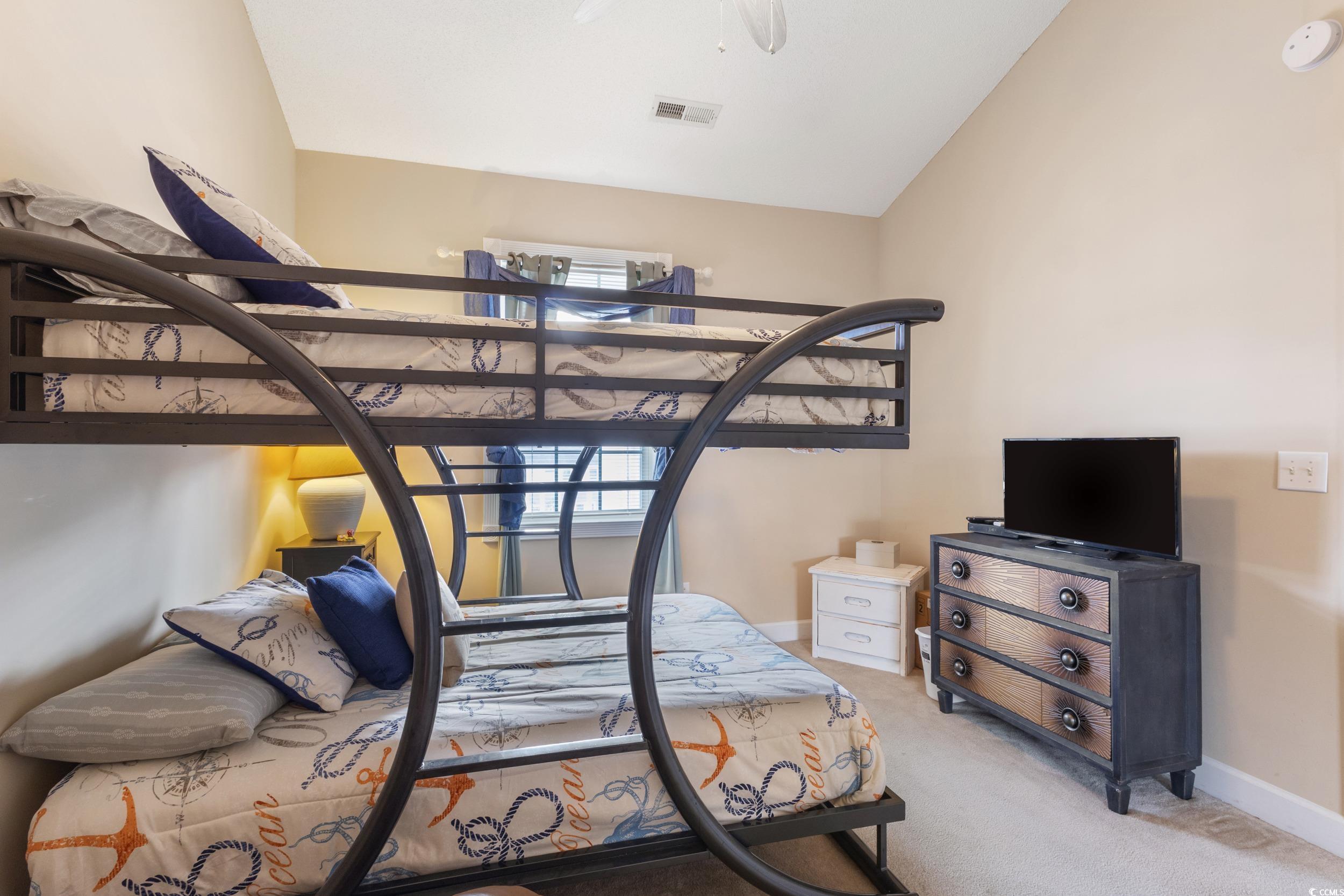 4781 Wild Iris Drive, Unit 301 Myrtle Beach, SC 29577 - Photo 23 of 33 Carpeted bedroom with lofted ceiling and ceiling fan