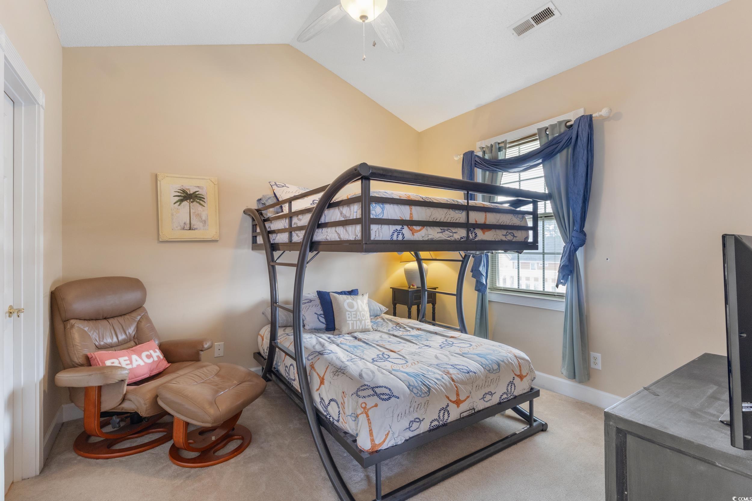 4781 Wild Iris Drive, Unit 301 Myrtle Beach, SC 29577 - Photo 24 of 33 Bedroom with vaulted ceiling, light colored carpet, and ceiling fan