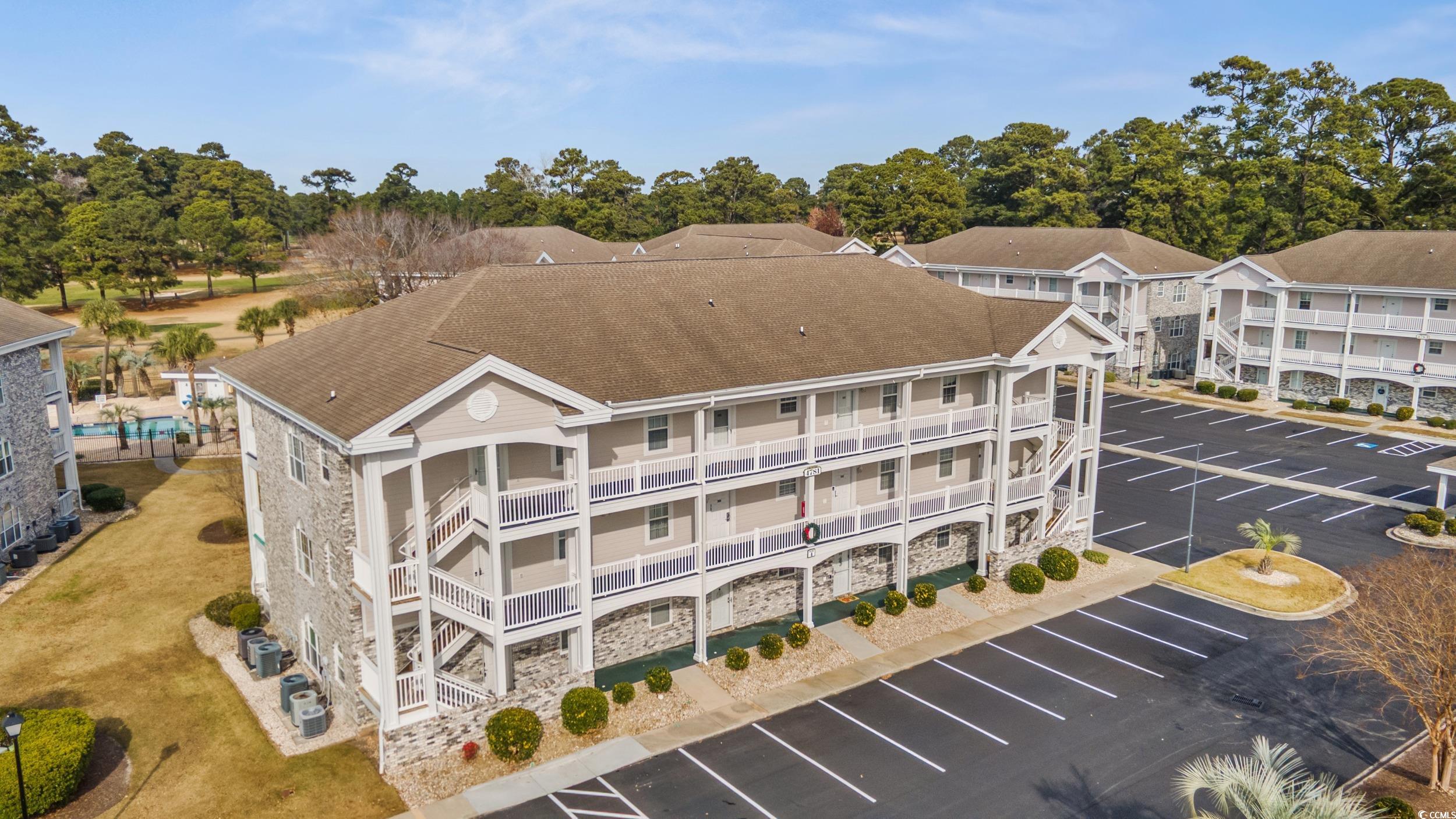 4781 Wild Iris Drive, Unit 301 Myrtle Beach, SC 29577 - Photo 28 of 33 View of yard featuring a community pool, a patio, and a balcony