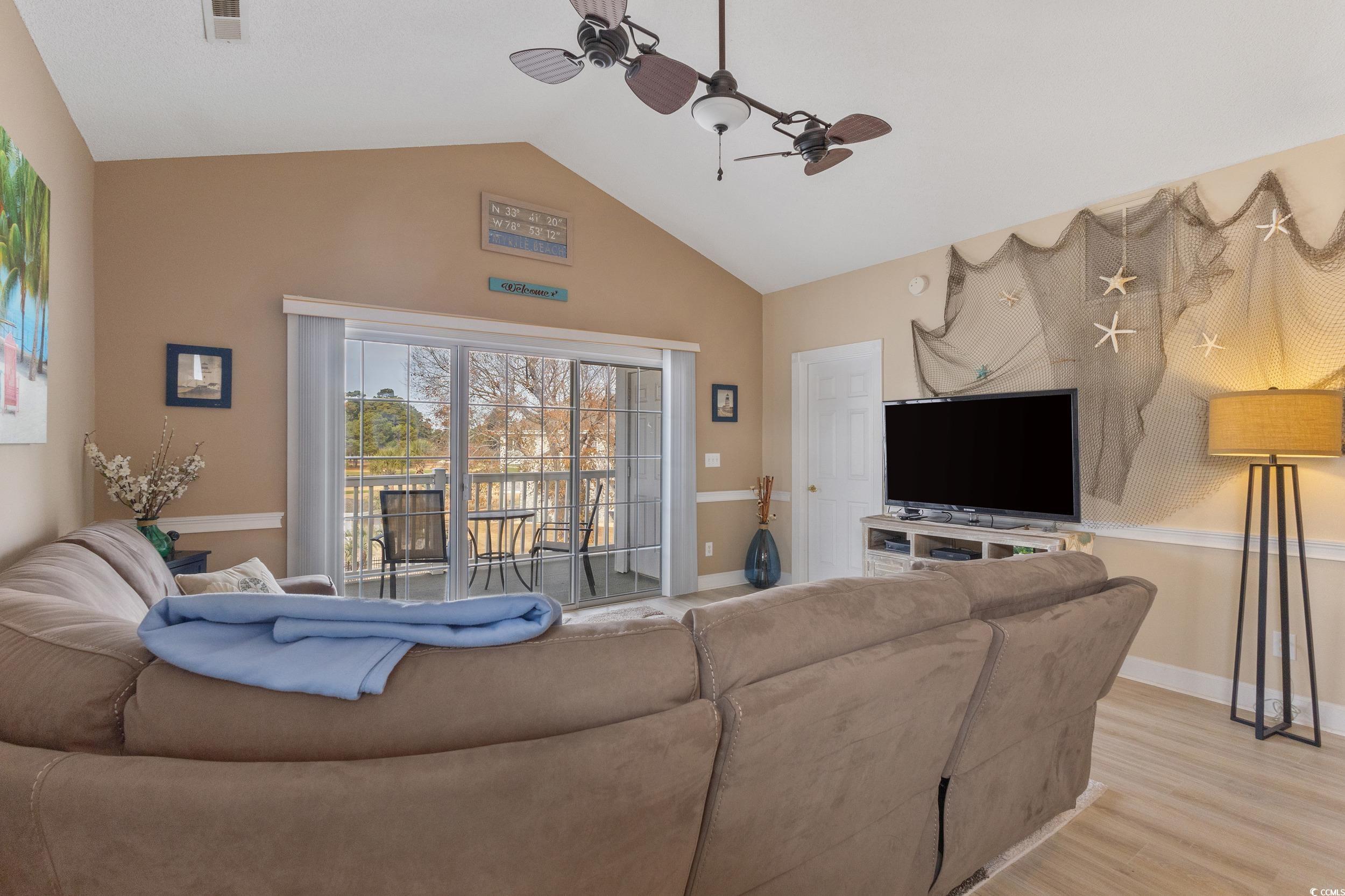 4781 Wild Iris Drive, Unit 301 Myrtle Beach, SC 29577 - Photo 4 of 33 Living room with ceiling fan, light wood-type flooring, and high vaulted ceiling