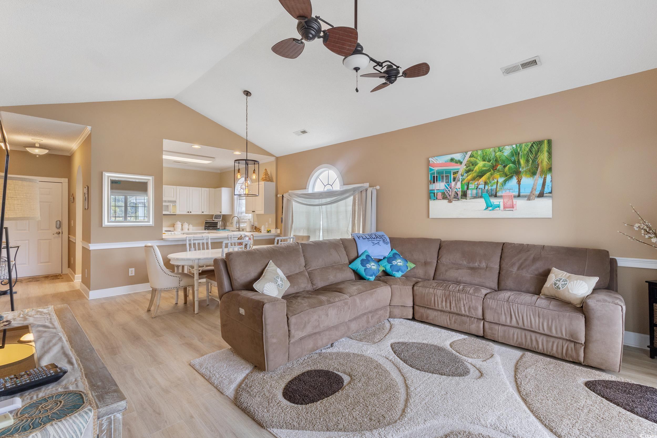 4781 Wild Iris Drive, Unit 301 Myrtle Beach, SC 29577 - Photo 5 of 33 Living area with a ceiling fan, vaulted ceiling, and light wood-style floors