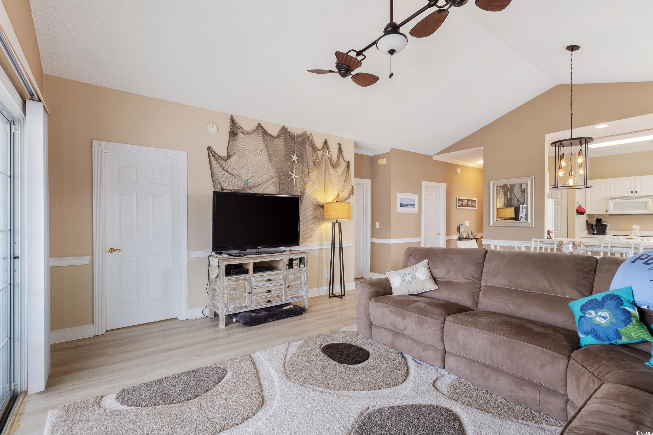 4781 Wild Iris Drive, Unit 301 Myrtle Beach, SC 29577 - Photo 6 of 33 Living room with ceiling fan, light wood-style flooring, vaulted ceiling, and a chandelier