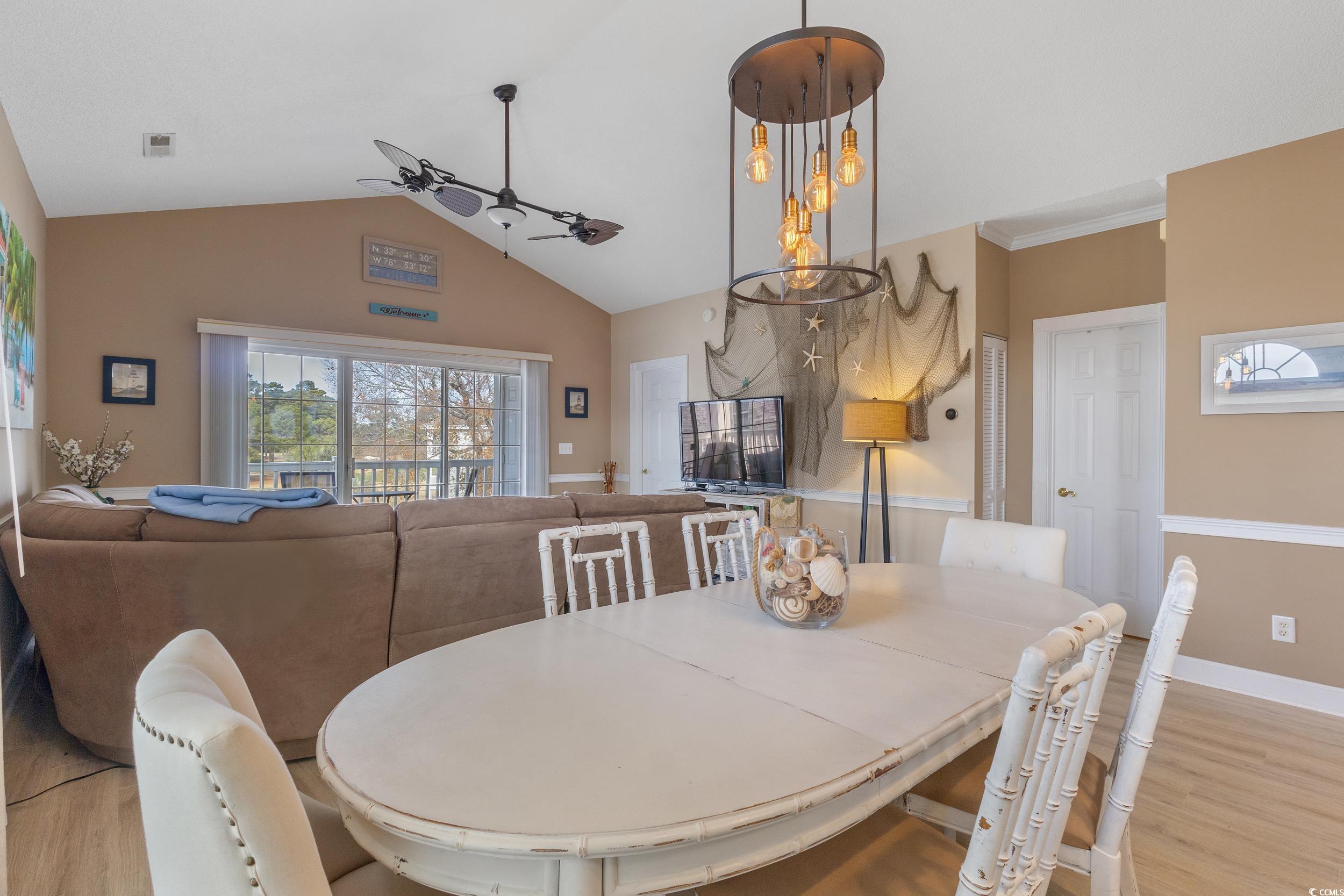 4781 Wild Iris Drive, Unit 301 Myrtle Beach, SC 29577 - Photo 8 of 33 Dining area featuring a ceiling fan, light wood-type flooring, and vaulted ceiling