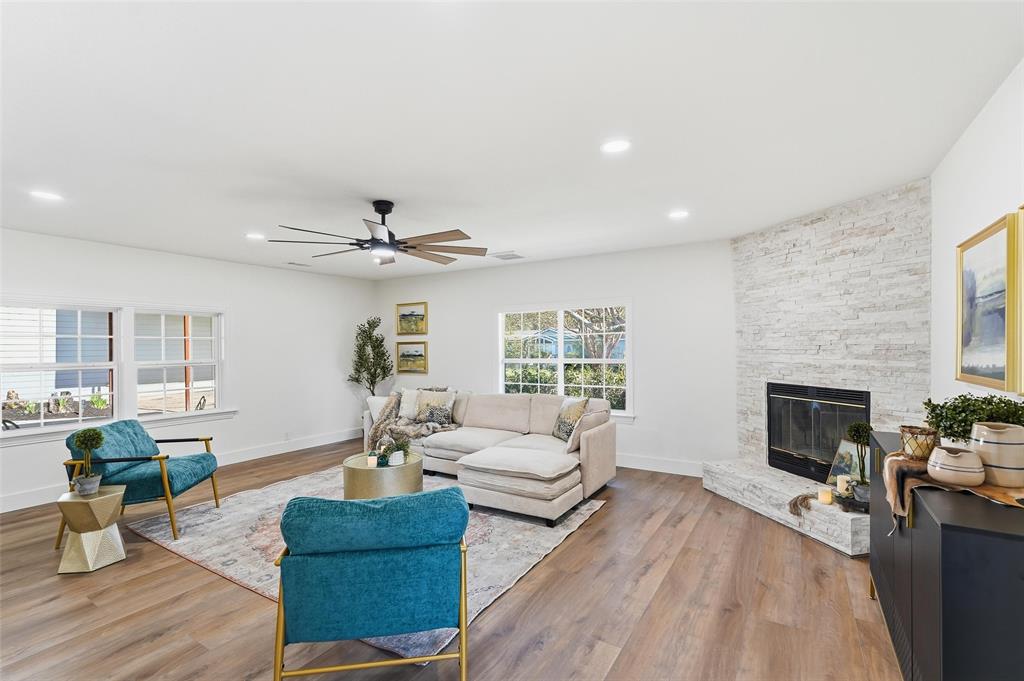 9938 John Flowers Road Wills Point, TX 75169 - Photo 16 of 40 Living room featuring a ceiling fan, a fireplace, light wood-type flooring, and recessed lighting