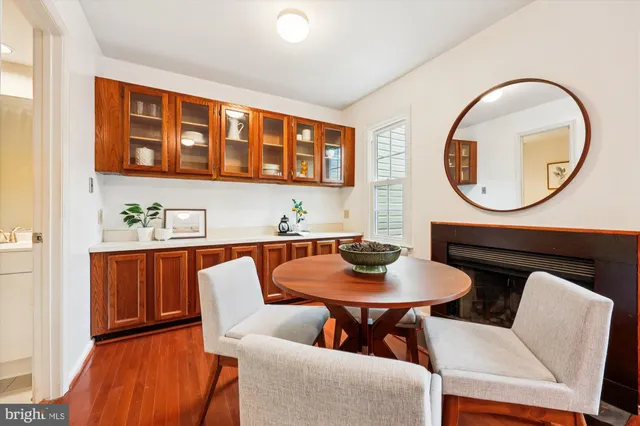 a dining room with furniture and a mirror