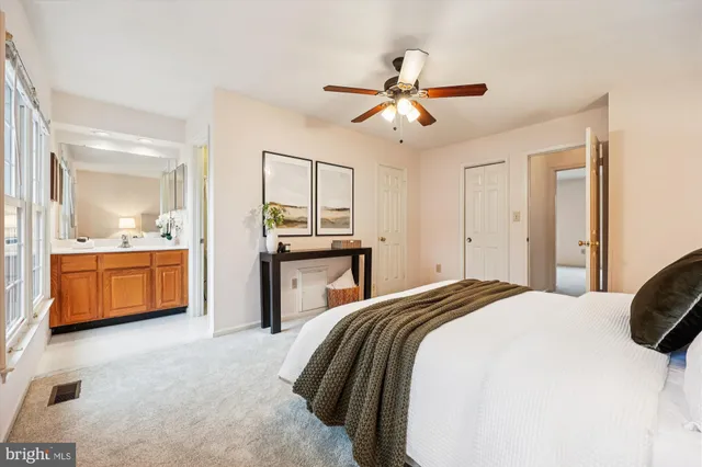 a spacious bedroom with a bed and a chandelier