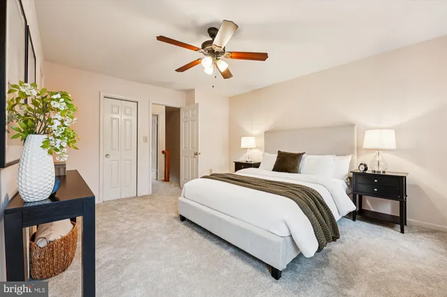 a spacious bedroom with a bed and a dresser