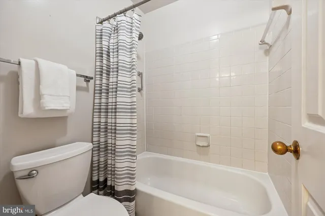 a bathroom with a toilet and a bathtub