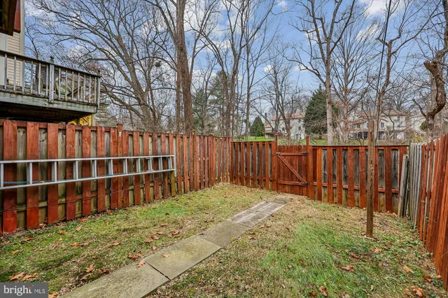 a view of a house with wooden deck and furniture