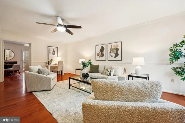 a living room with furniture and a large mirror