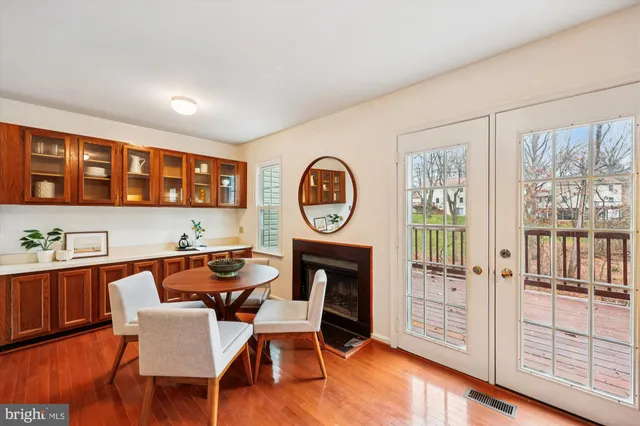 a dining room with furniture a rug and a large window