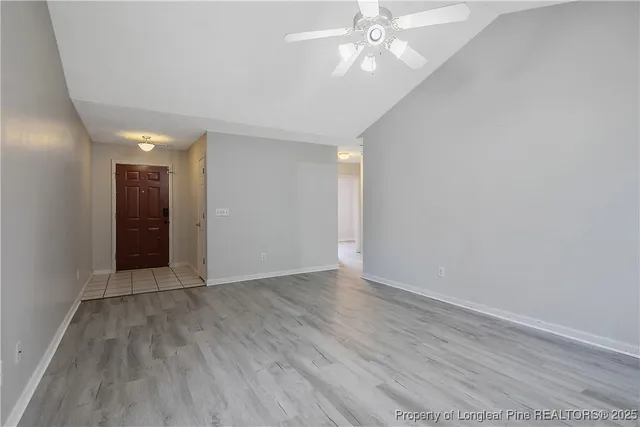 a view of an empty room with wooden floor