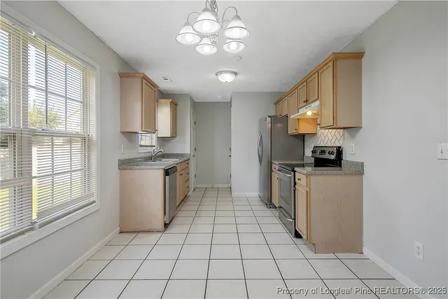 a kitchen with a stove a sink and a refrigerator