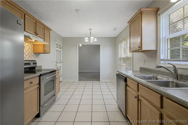 a kitchen with a sink cabinets and window