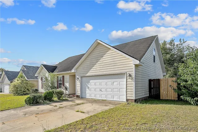 a view of a house with a yard and garage