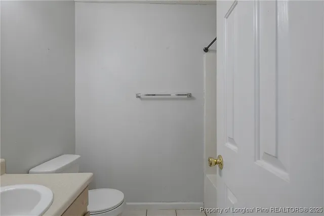 a white toilet sitting next to a bathroom sink