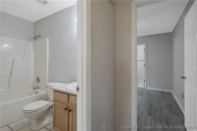 a white toilet sitting next to a bathroom sink
