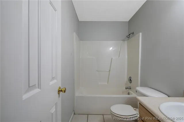a bathroom with a toilet a sink and bathtub