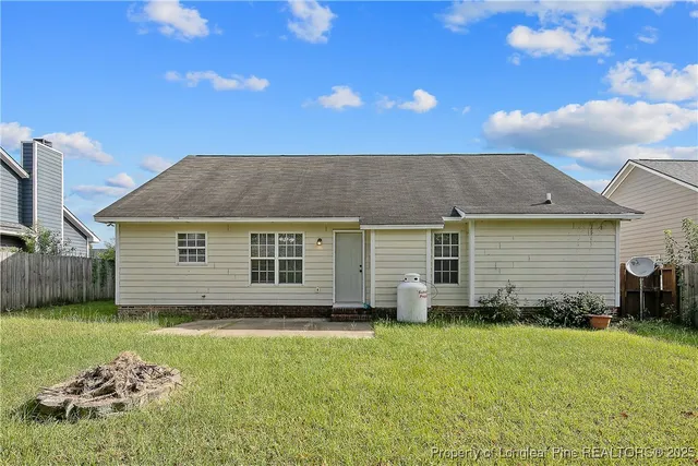 a view of a house with a yard