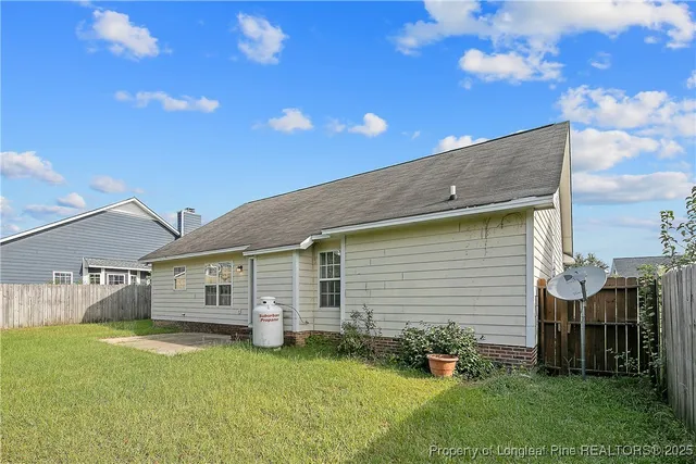 a view of a backyard with plants and a patio