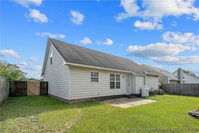 a backyard of a house with table and chairs