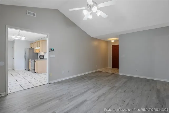 a view of an empty room and wooden floor